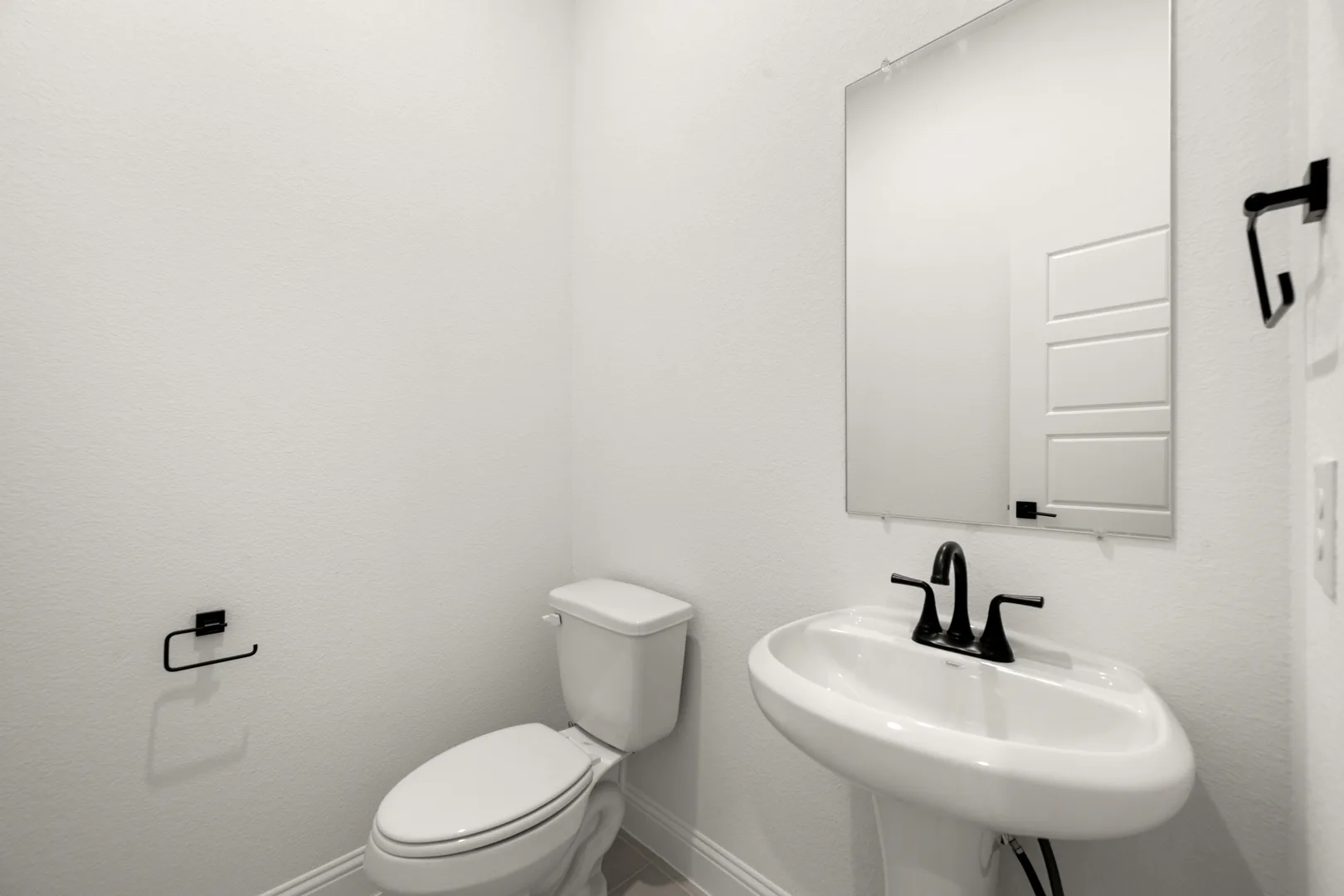 Powder bathroom in a transitional ranch style home by Kindred Homes