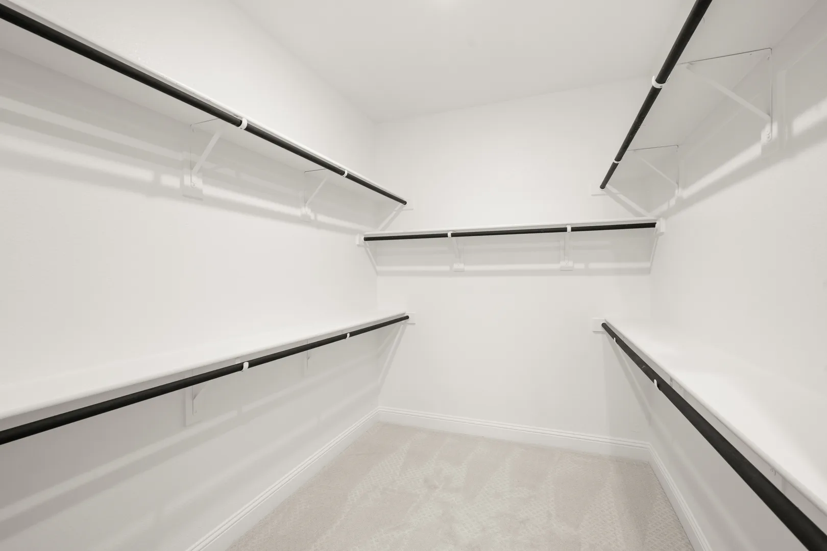 Walk-in closet in a transitional ranch style home by Kindred Homes