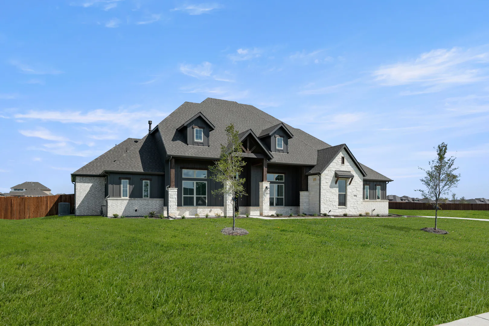 Side view of exterior of a modern Texas ranch style home by Kindred Homes