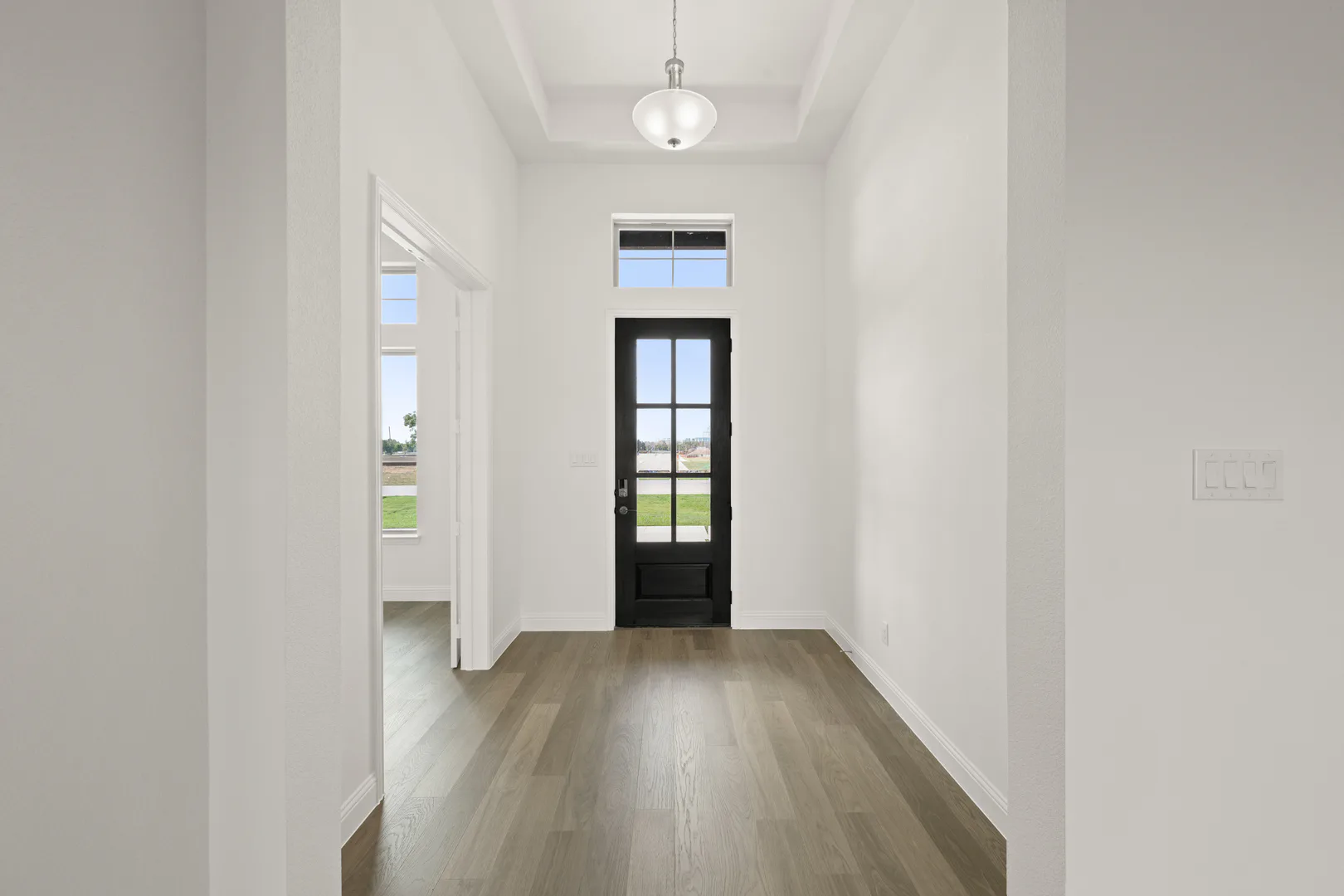Entryway in a modern Texas ranch style home by Kindred Homes
