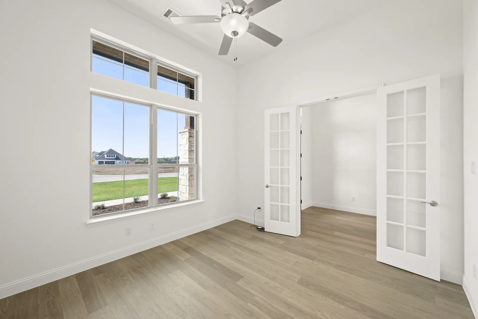Study in a modern Texas ranch style home by Kindred Homes