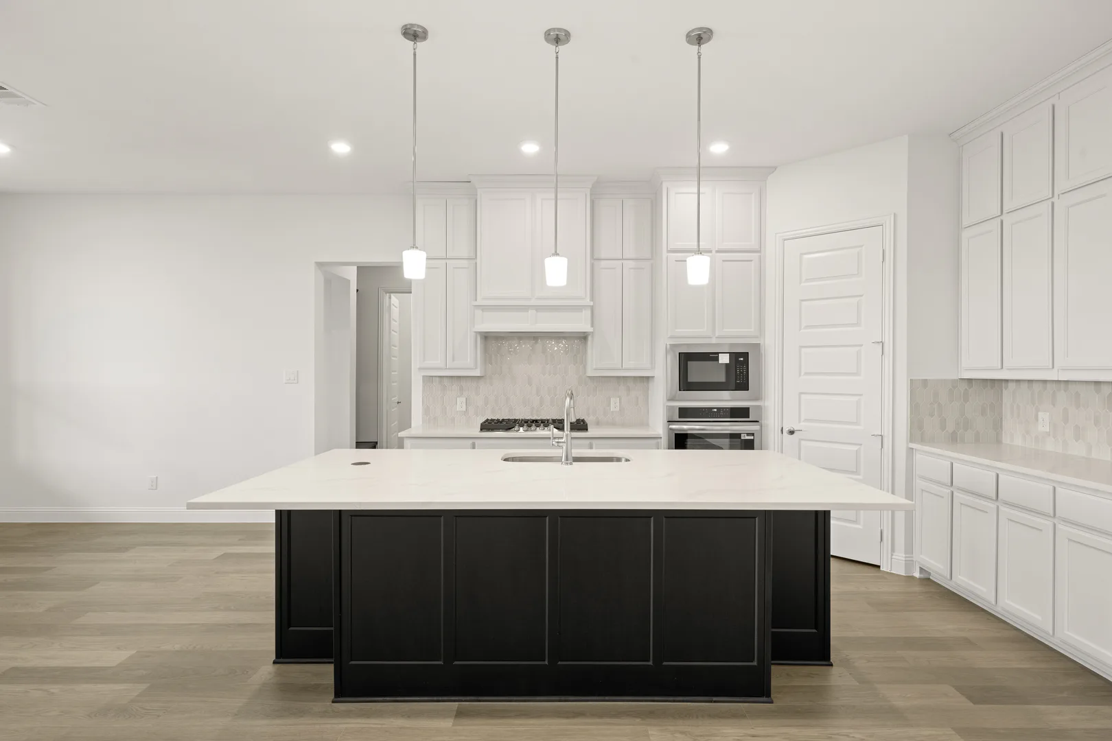 Kitchen in a modern Texas ranch style home by Kindred Homes