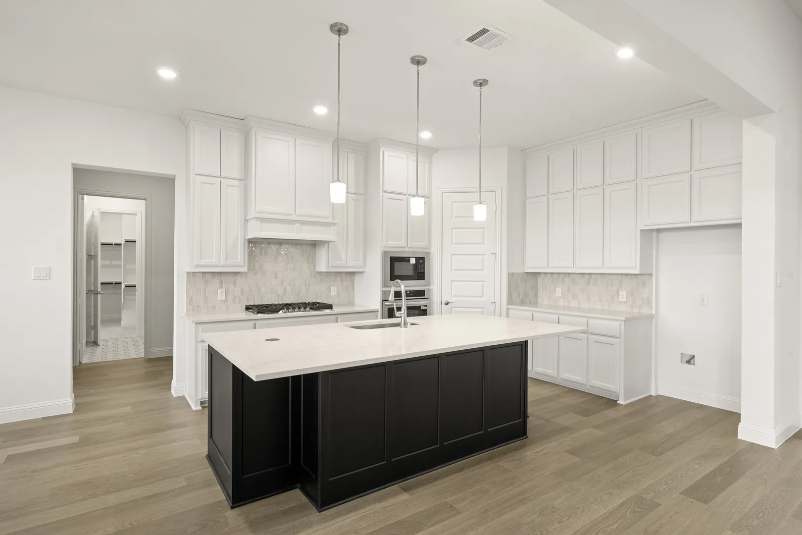 Kitchen in a modern Texas ranch style home by Kindred Homes