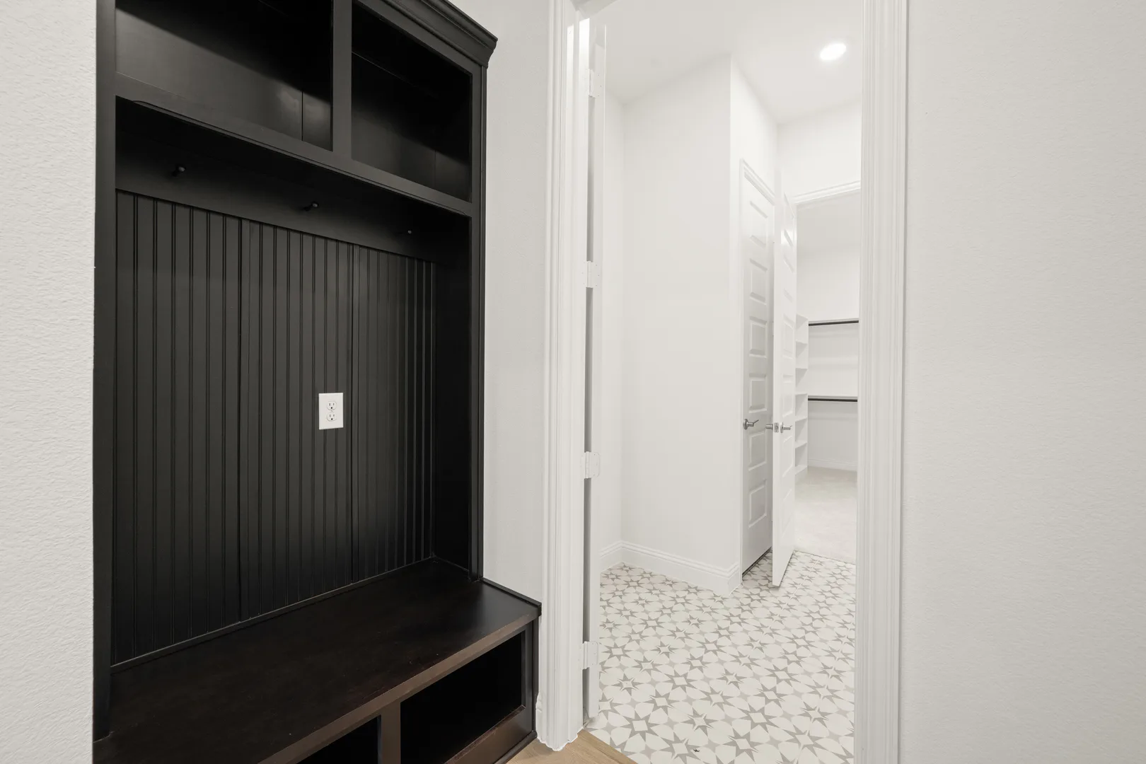Mud room in a modern Texas ranch style home by Kindred Homes