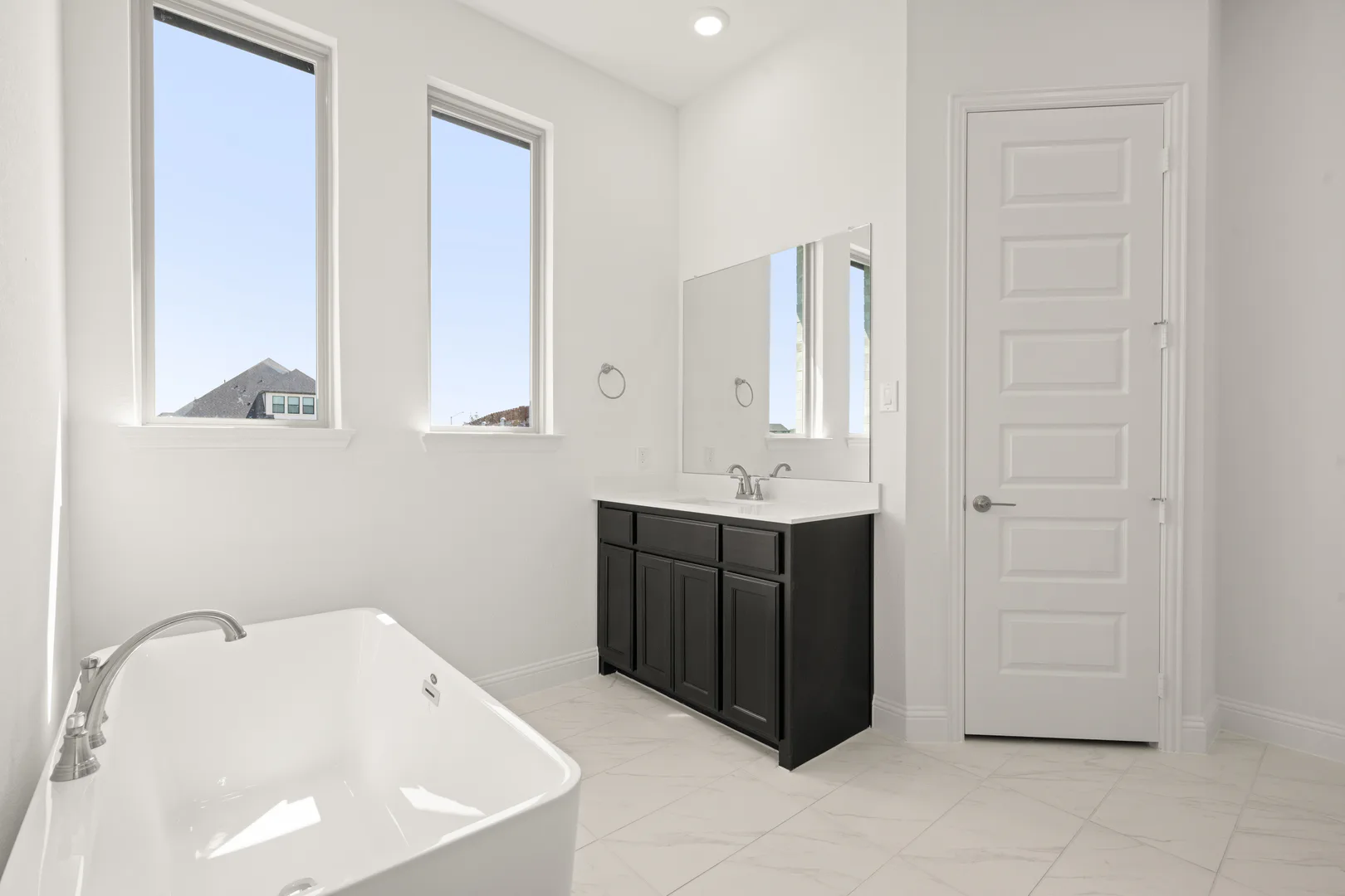 Primary bathroom in a modern Texas ranch style home by Kindred Homes