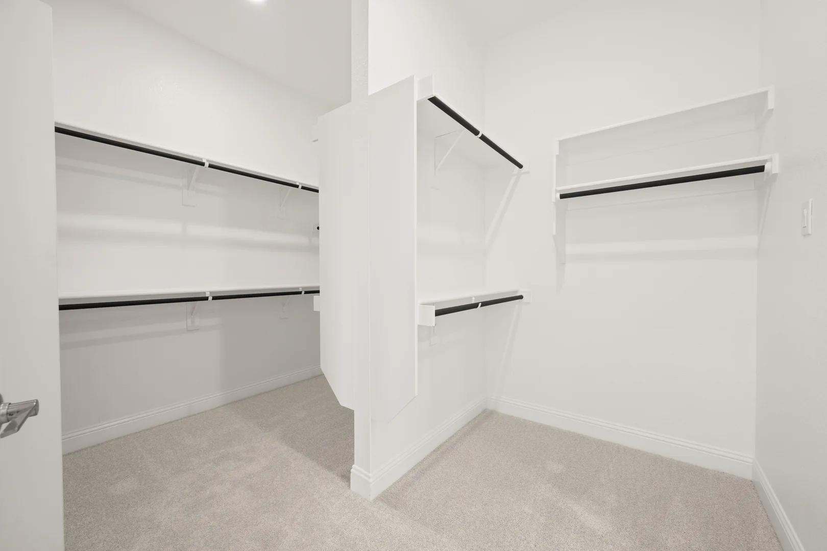 Walk-in closet in a modern Texas ranch style home by Kindred Homes