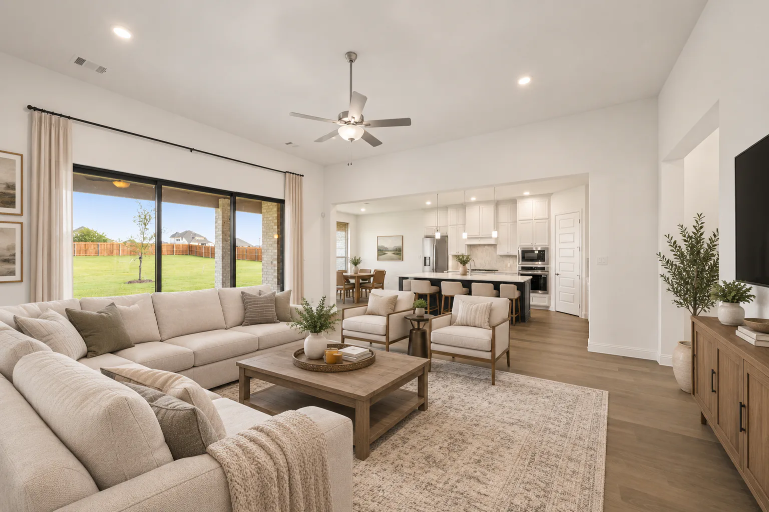 Virtually staged living room and kitchen in a modern Texas ranch style home by Kindred Homes