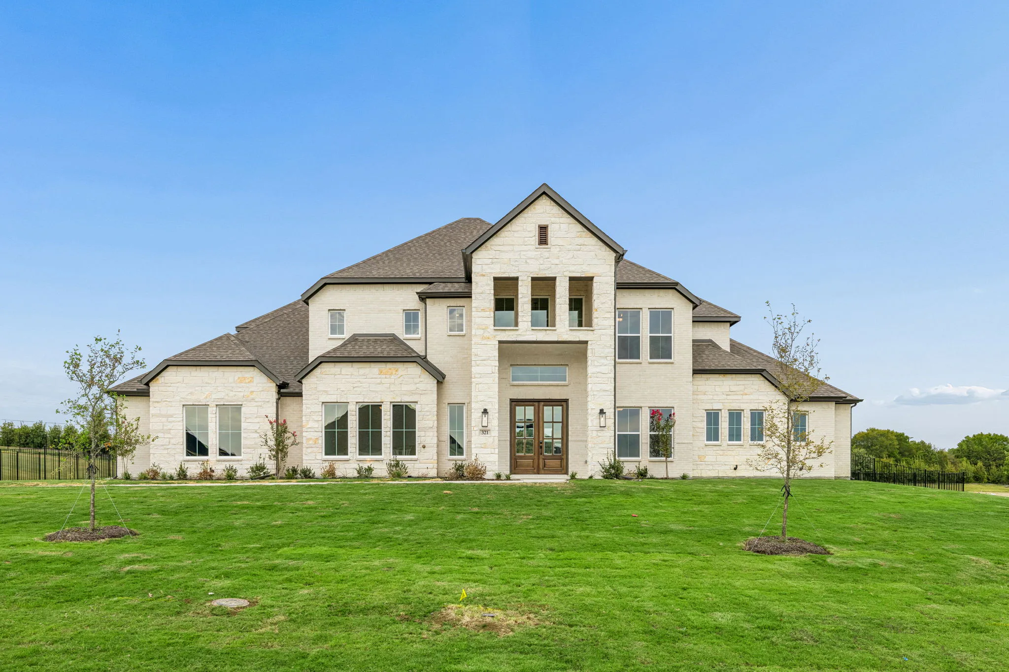 Exterior of a transitional hill country style home by Kindred Homes.