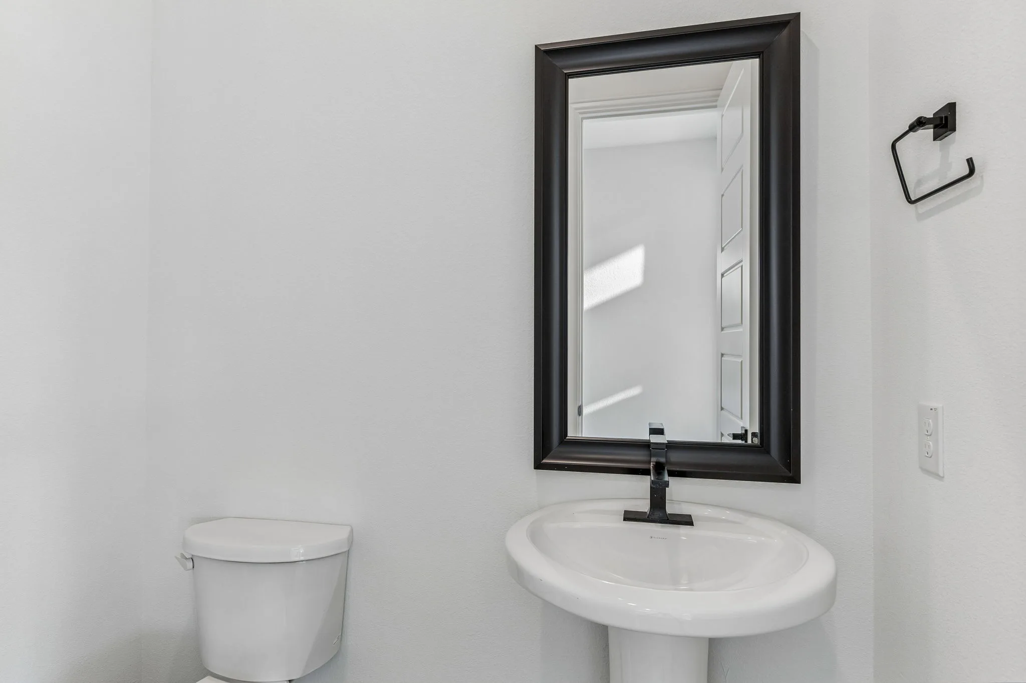 Powder bathroom in a transitional hill country style home by Kindred Homes.