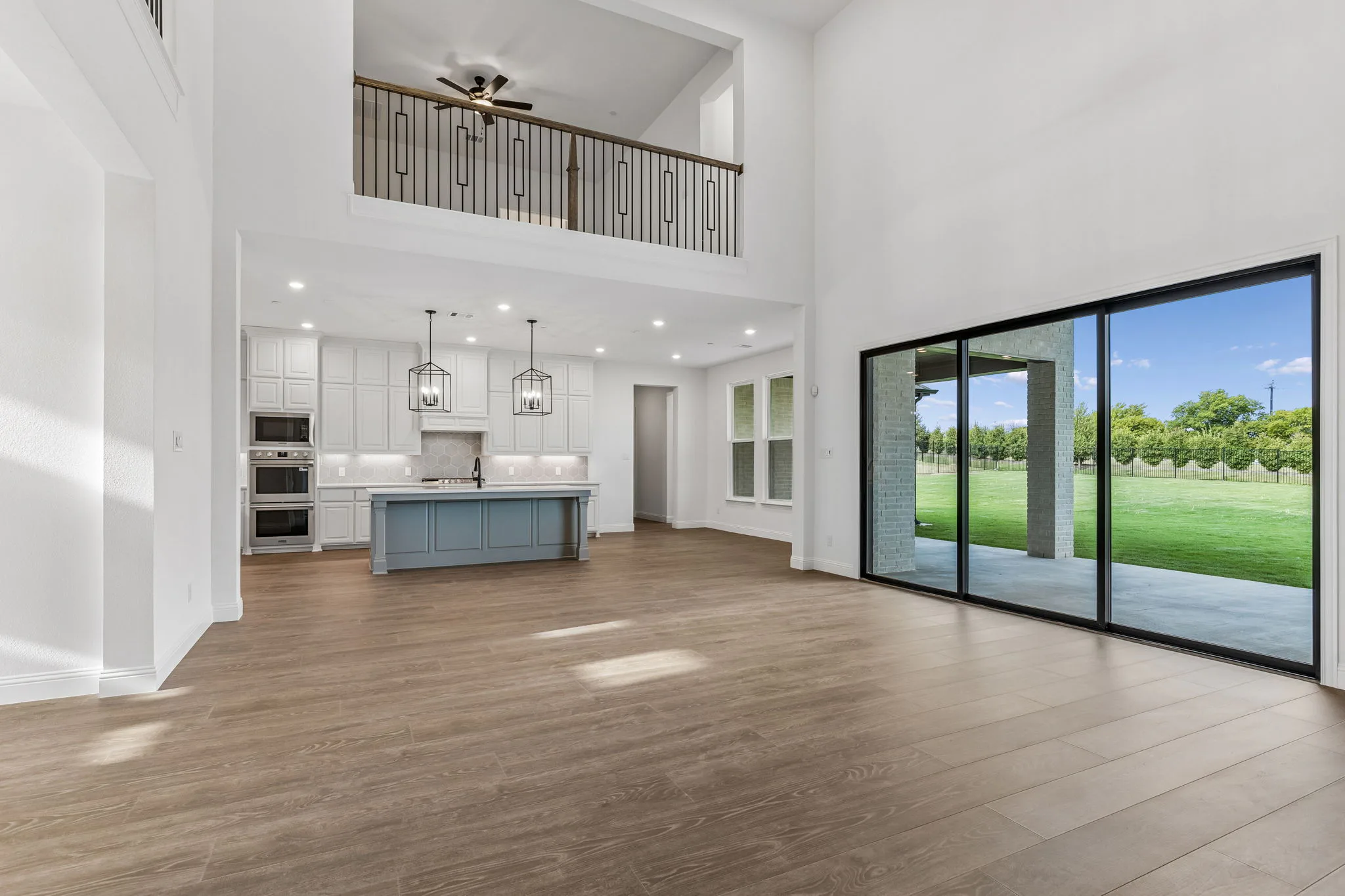 Living room and kitchen in a transitional hill country style home by Kindred Homes.