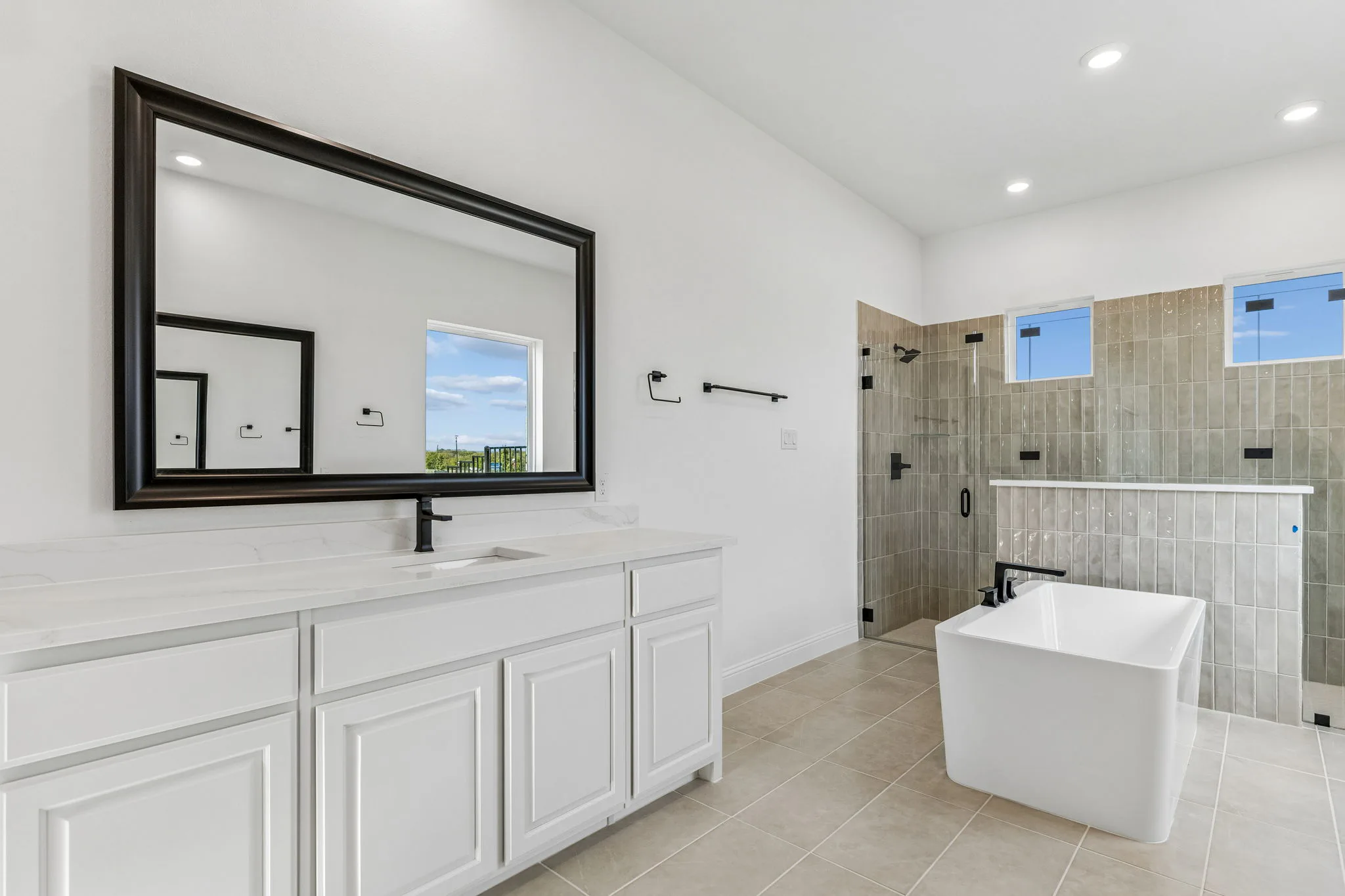 Primary bathroom in a transitional hill country style home by Kindred Homes.