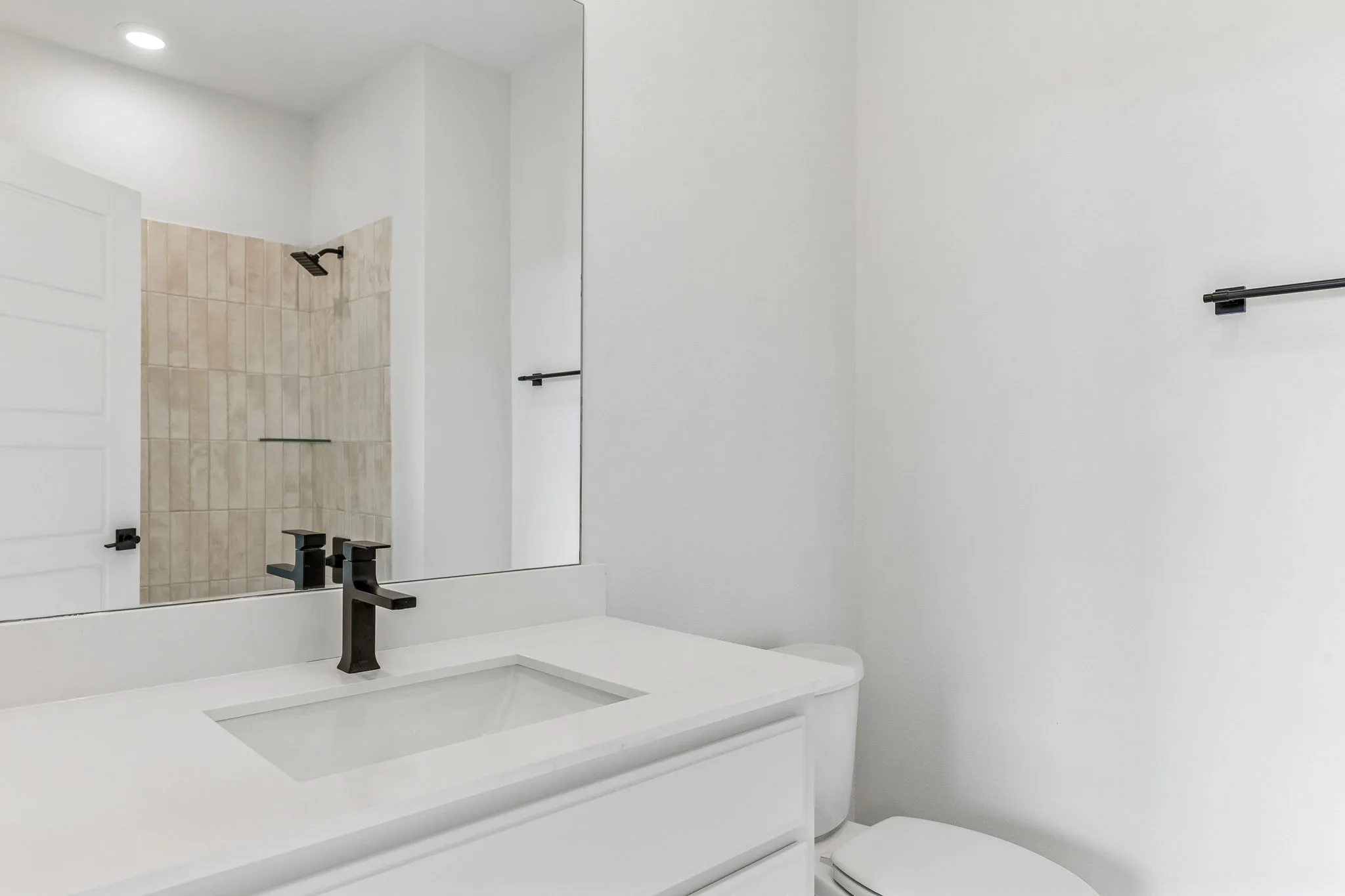 Secondary bathroom in a transitional hill country style home by Kindred Homes.