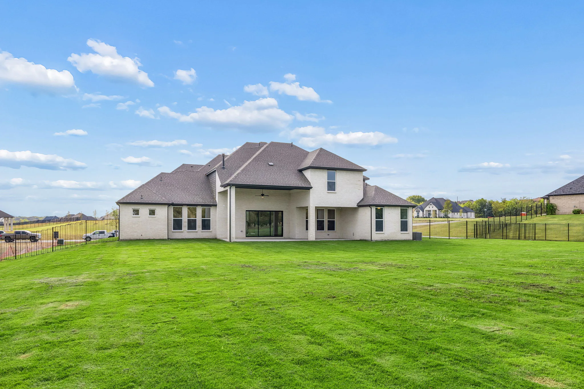 Spacious backyard of a transitional hill country style home by Kindred Homes.