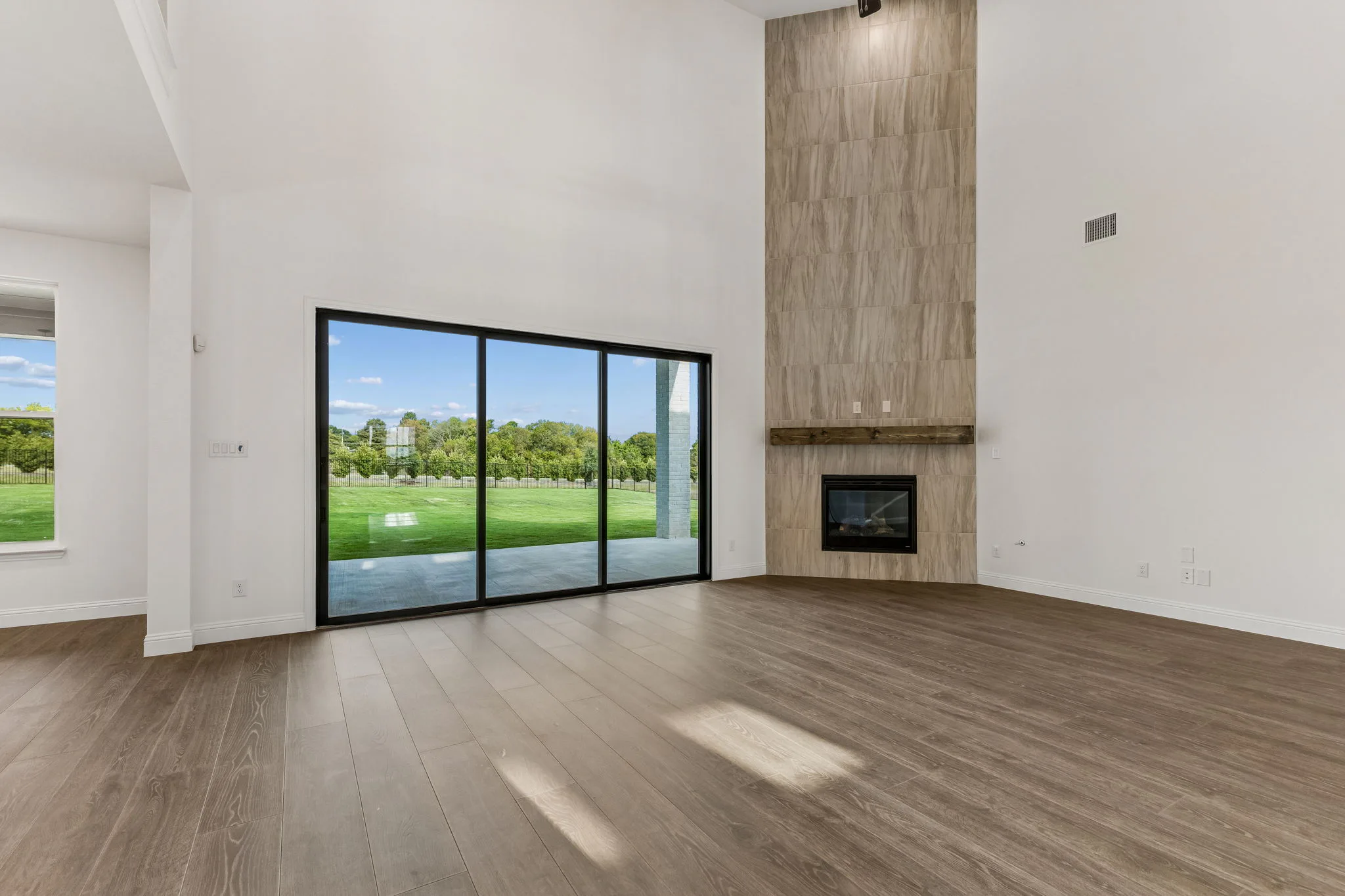 Living room with fireplace in a transitional hill country style home by Kindred Homes.