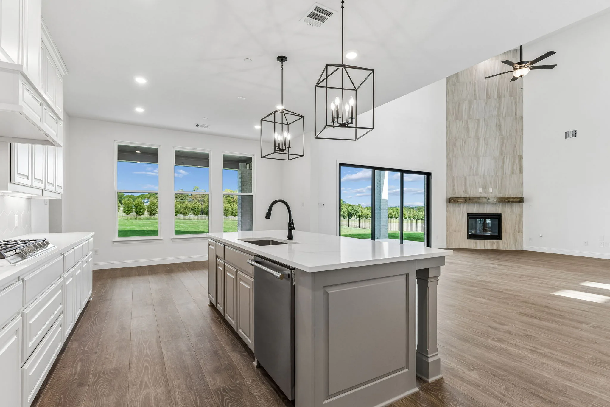 Kitchen and living room in a transitional hill country style home by Kindred Homes.