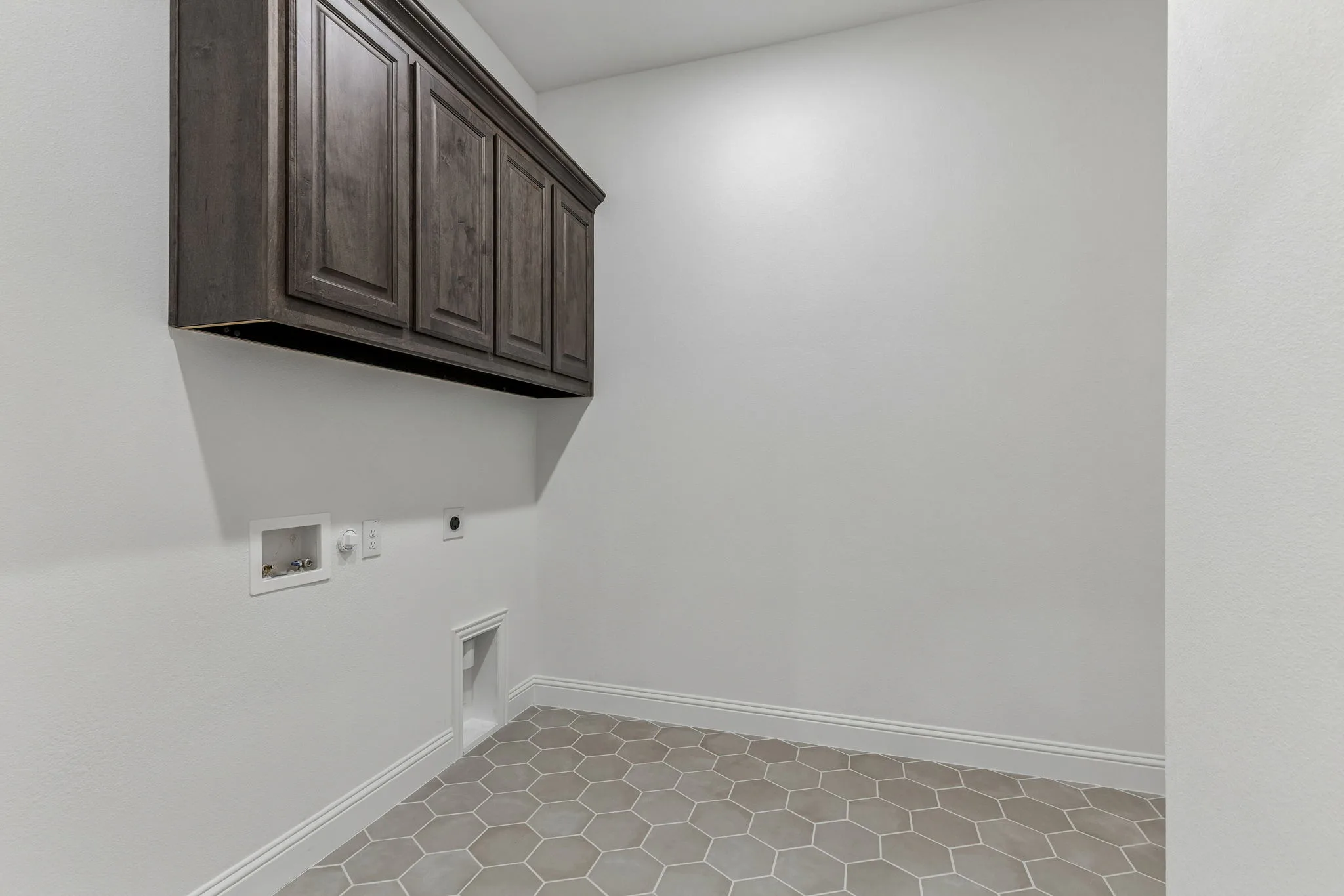 Utility room in a transitional hill country style home by Kindred Homes.