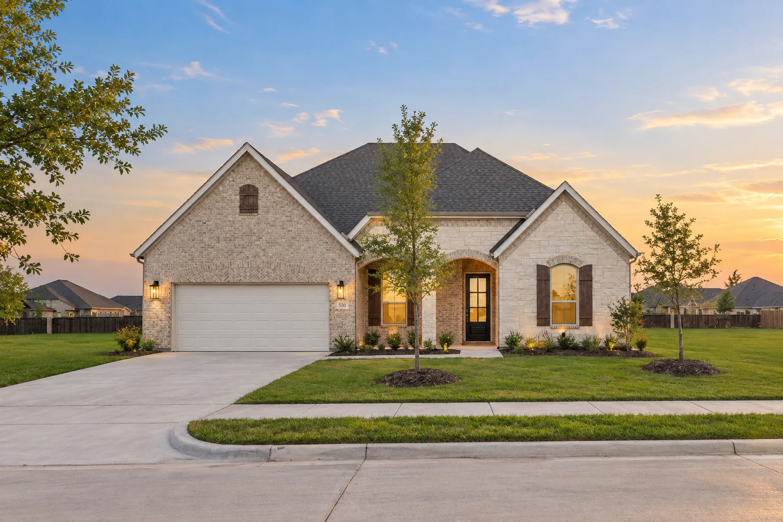 Front exterior of a modern tudor style home by Kindred Homes
