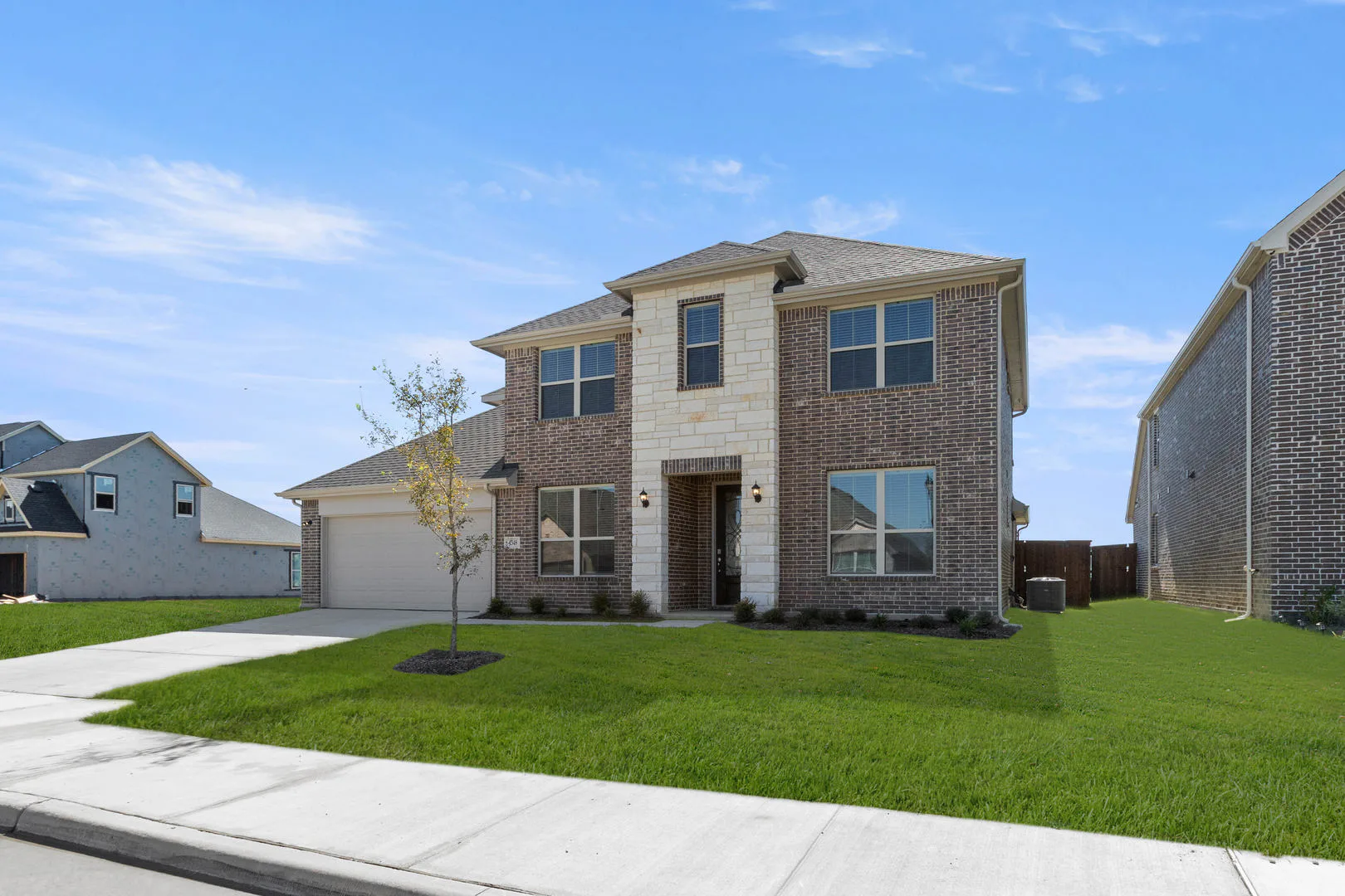 Side view exterior of a new traditional style home by Kindred Homes