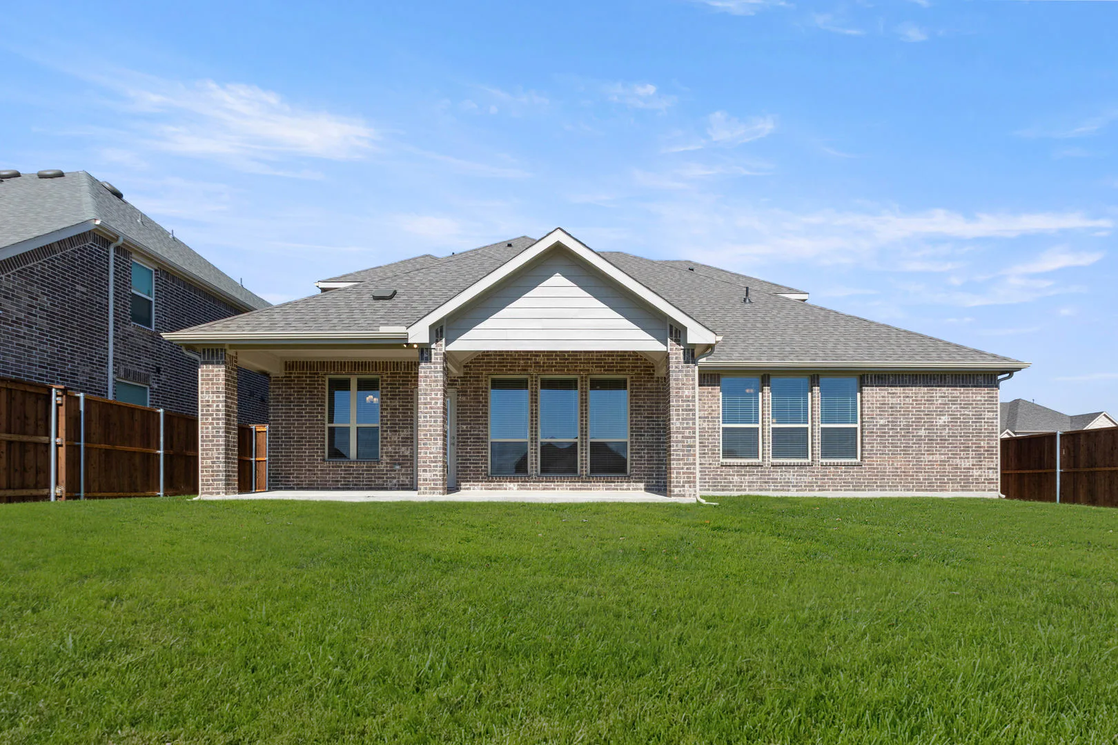 Back exterior of a new traditional style home by Kindred Homes