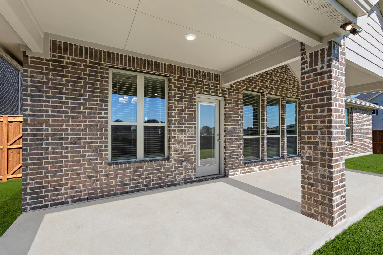 Covered patio of a new traditional style home by Kindred Homes
