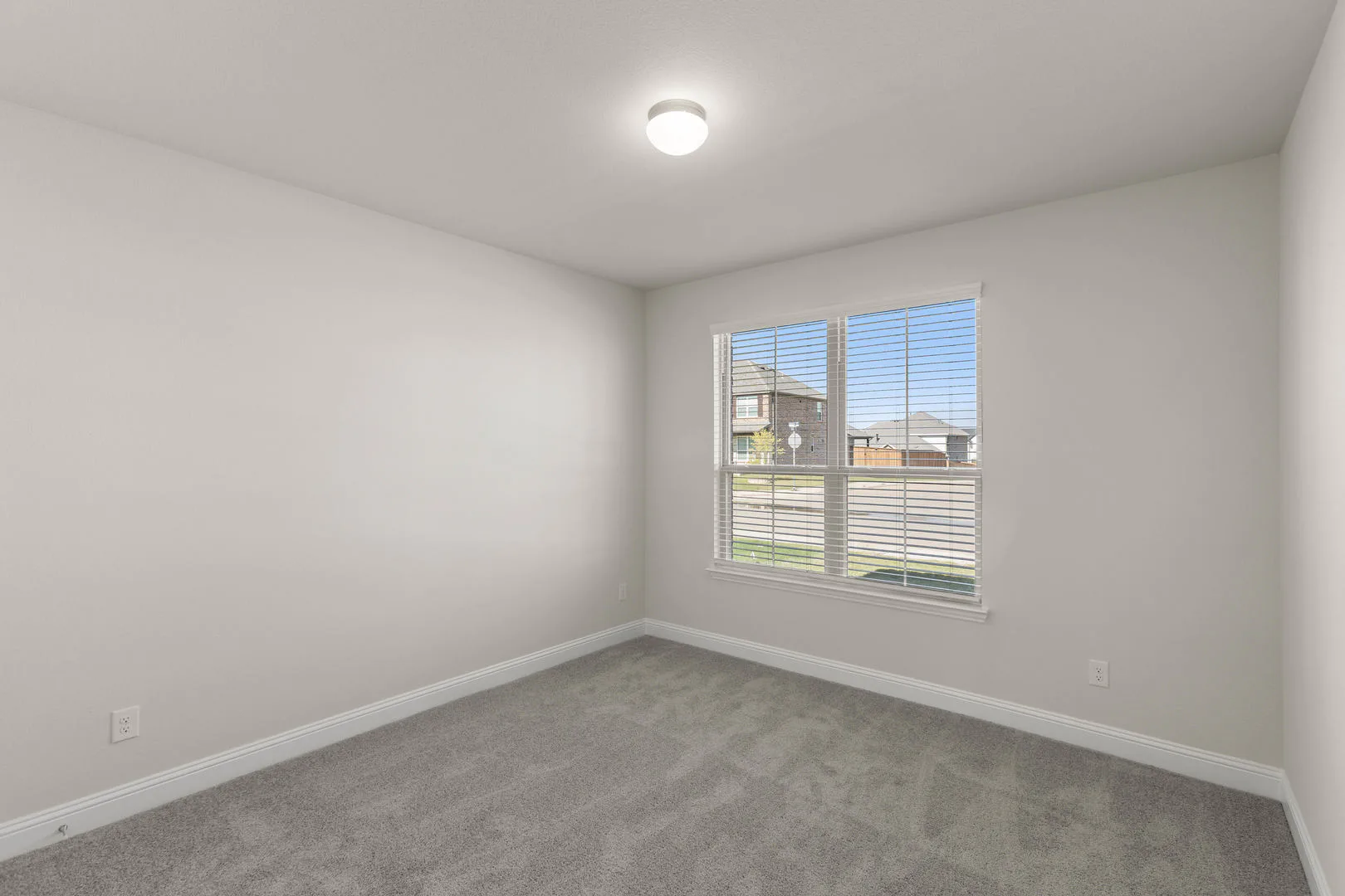 Secondary bedroom in a new traditional style home by Kindred Homes