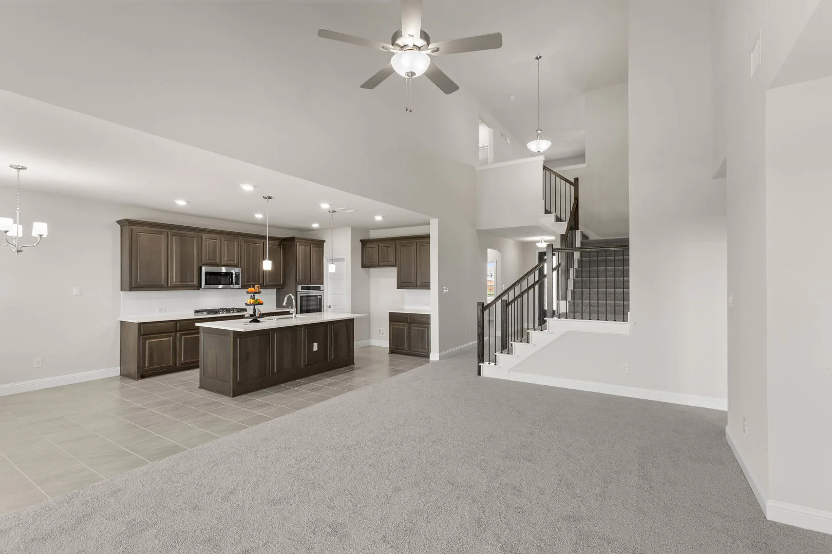 Living room and kitchen in a new traditional style home by Kindred Homes