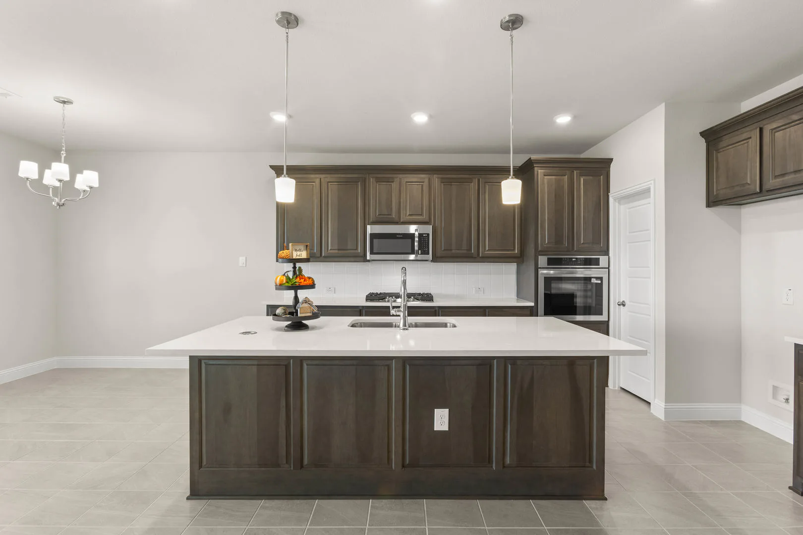 Kitchen in a new traditional style home by Kindred Homes