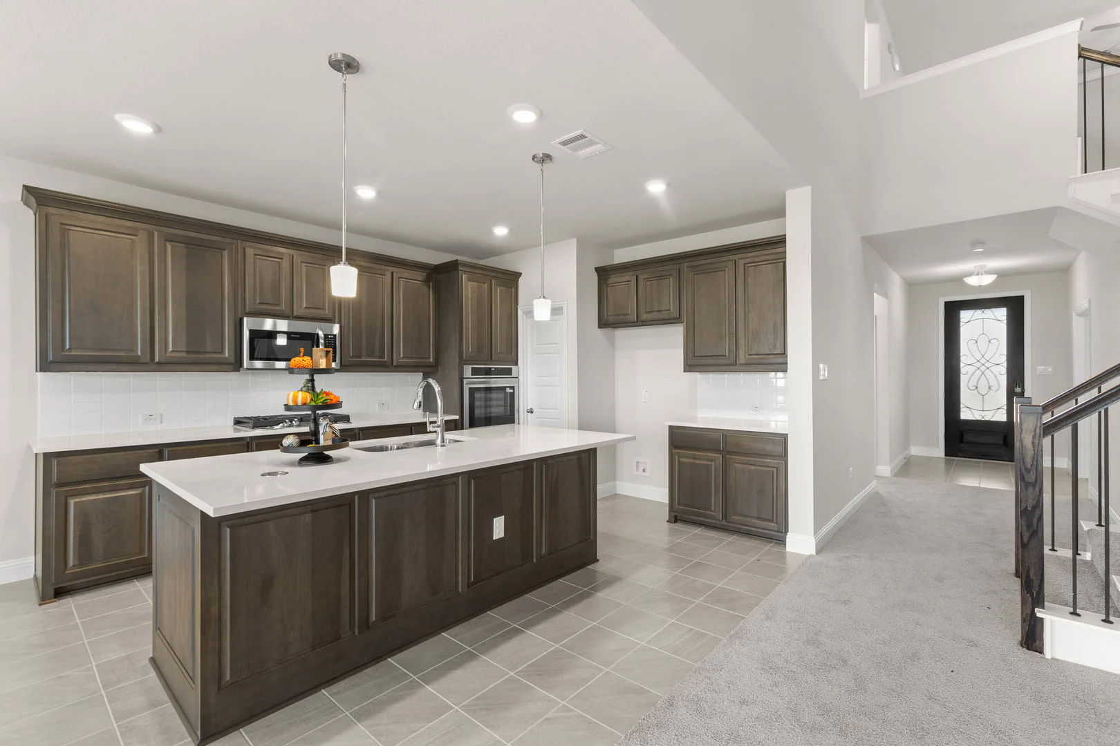 Kitchen and entryway in a new traditional style home by Kindred Homes