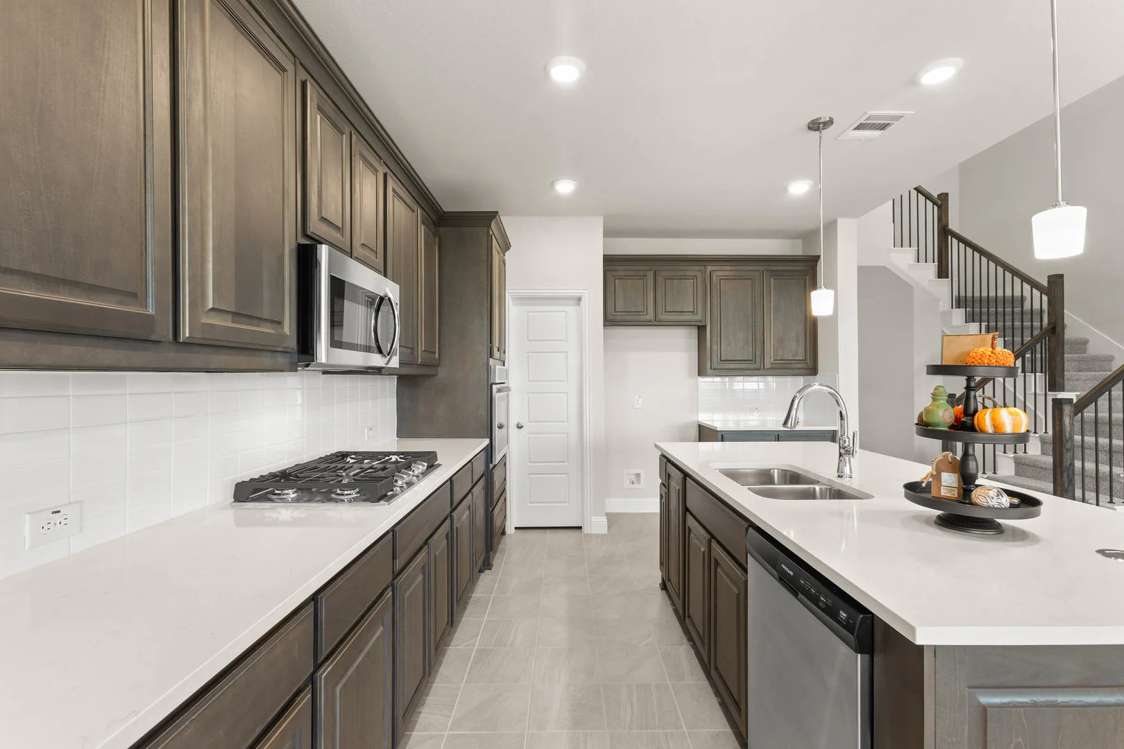 Kitchen in a new traditional style home by Kindred Homes