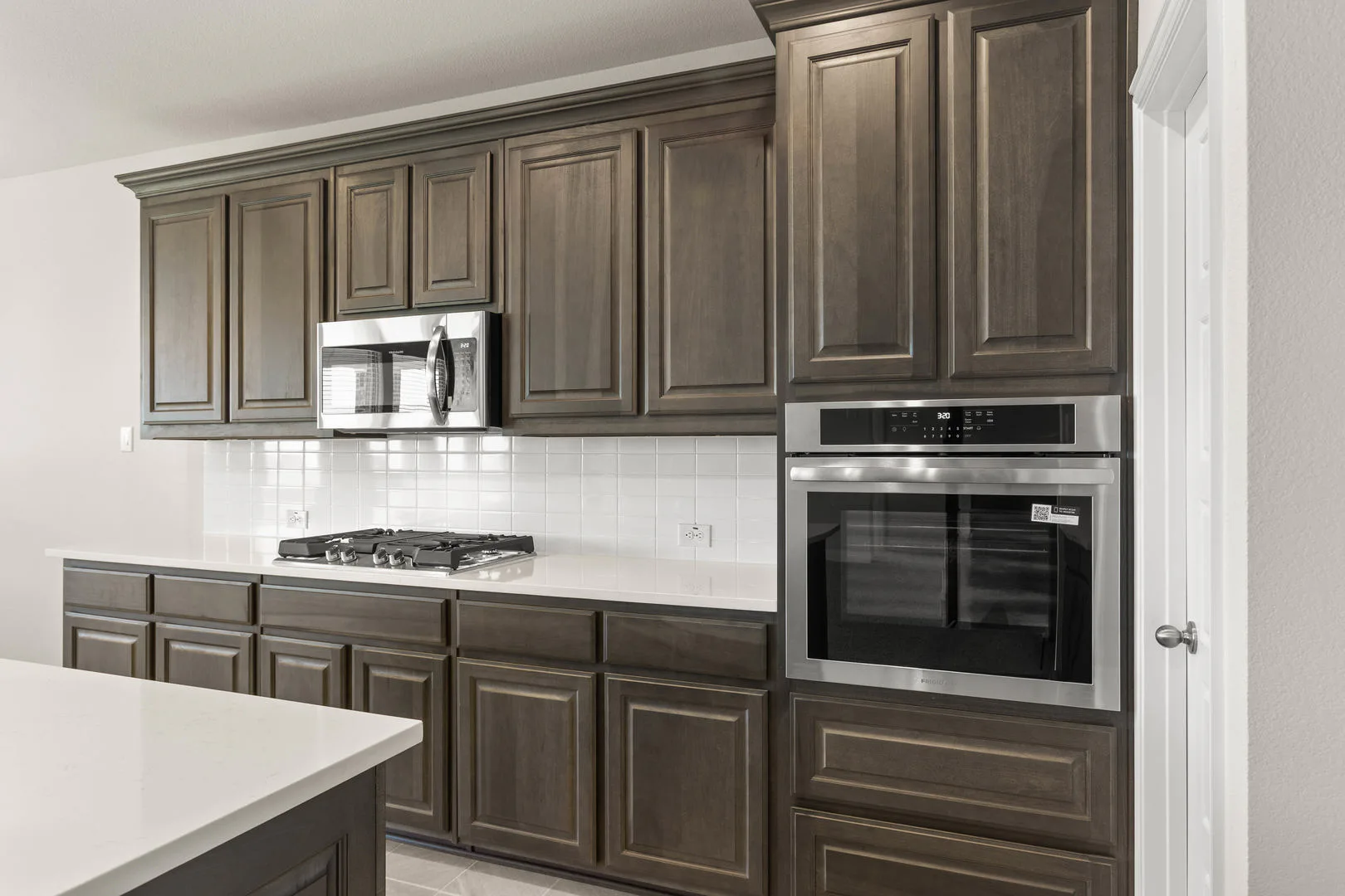 Kitchen in a new traditional style home by Kindred Homes