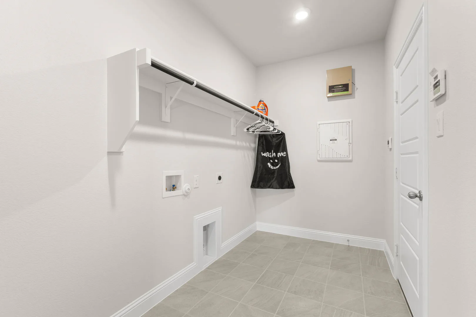 Utility room in a new traditional style home by Kindred Homes