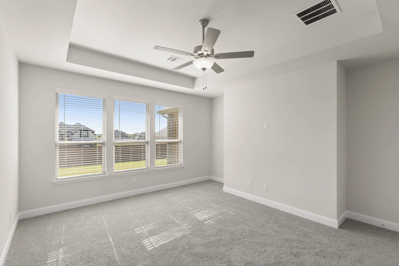 Primary suite in a new traditional style home by Kindred Homes
