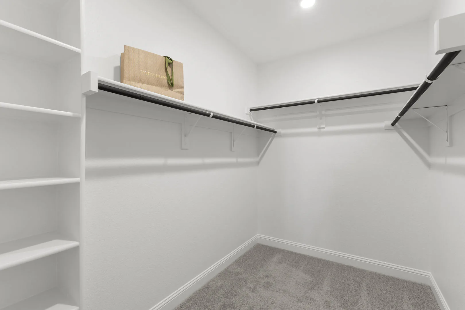 Walk-in closet in a new traditional style home by Kindred Homes