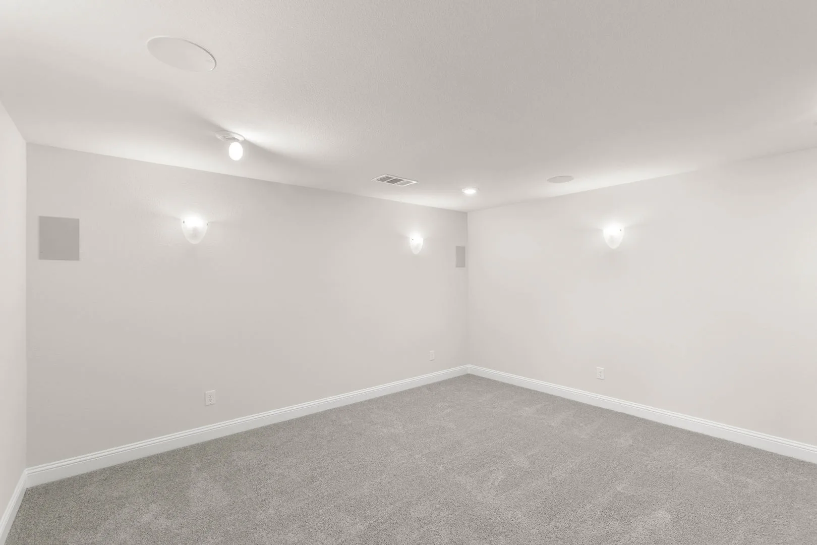 Media room in a new traditional style home by Kindred Homes